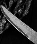 Close-up of Ultra Sharp Meat Cleaver For DIY Damascus Steel Blank Blade Knife Kit showing Damascus pattern on blade edge.