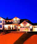 JUDYSSY Outdoor Solar Flood Lights illuminating a modern home at night, showcasing landscape lighting effectiveness.