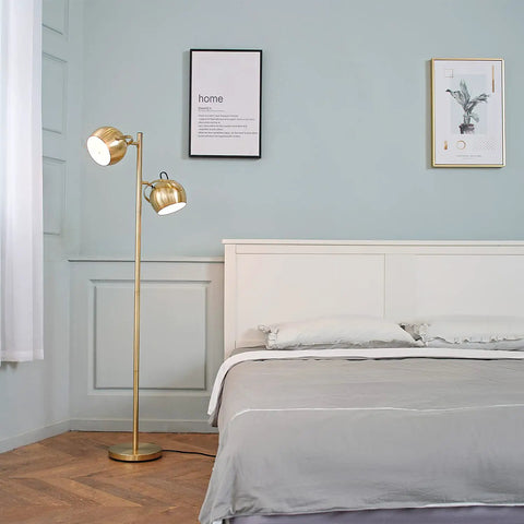 Miles 61 Inch Two Light Floor Lamp in Matte Brass Finish with Adjustable Heads and In Line On Off Foot Switch beside bed