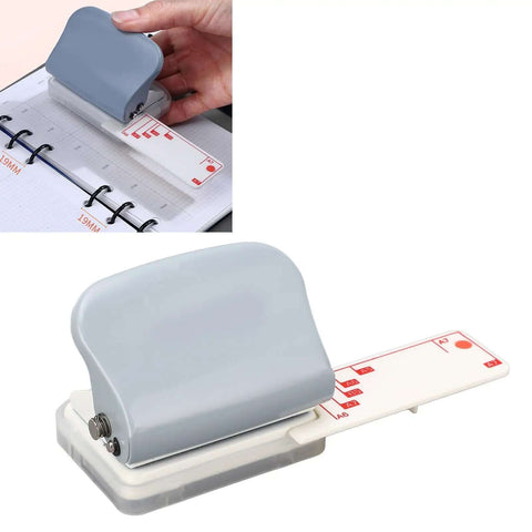 Gray handheld Portable 3 Hole Punch for Scrapbooks and Crafts in use, showing adjustable hole pattern and integrated ruler on desk.