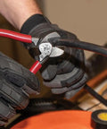 Sleek Six Point Five Inch Compact Cable Cutter Featuring High Leverage Action For Hella Easy Aluminum And Copper Wire Snipping With Zero Mechanical Hassle And Top Shelf American Forged Steel, cutting red and black wires.