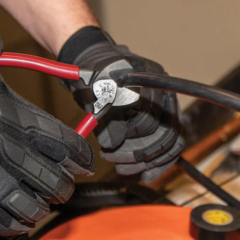 Sleek Six Point Five Inch Compact Cable Cutter Featuring High Leverage Action For Hella Easy Aluminum And Copper Wire Snipping With Zero Mechanical Hassle And Top Shelf American Forged Steel, cutting red and black wires.