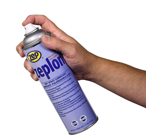 Person holding an 11 oz can of Heavy Duty Dry Spray Lubricant With PTFE For Industrial Use, sprayer nozzle visible
