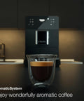 Kick Back And Sip Perfection With This Ultra Quiet Fully Automatic Bean To Cup Coffee And Espresso Machine Featuring A Silent Steel Grinder And Hassle Free One Touch Milk Frother For Serious Barista Level Coffee At Home - espresso in clear glass cup.