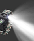 Survival Paracord Bracelet With Compass And LED Light shining bright, showcasing reflective cord and camping tools, emergency gear