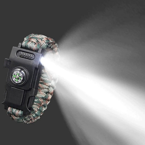 Survival Paracord Bracelet With Compass And LED Light shining bright, showcasing reflective cord and camping tools, emergency gear