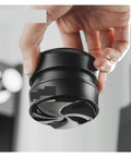Hella Smooth Espresso Bed Leveler Cyclone Coffee Distributor Spinner For 51 58 Mm Portafilters held in a hand, modern design, high heat proof material.