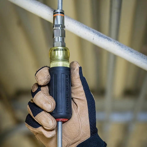 Person using Do-It-All 9-In-1 Pass-Through Nut Driver With Cushioned Grip on threaded rod for mechanical tasks