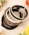 Snag These 7 Pack Of Ultra Comfy Headbands For Women Mixing Neutral Solid Knotted Padded Styles With Pearl Accents arranged on a table.