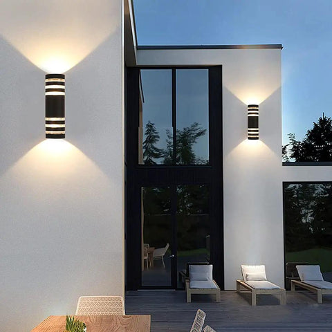 Built To Last All Weather Modern Outdoor Wall Sconce Lights Up Down Exterior Fixture Waterproof Matte Black Aluminum with Tempered Glass illuminating a patio