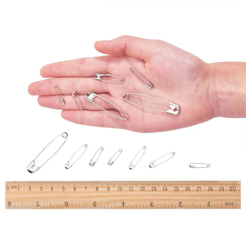450 Pack Real Deal Iron Safety Clasp Pins For Crafting And Tailoring displayed in hand for size comparison with ruler.
