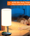 Multifunctional Table Lamp With 10W Fast Wireless Charger, USB Port, lit by bedside with sleeping woman, auto timer display