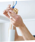 Hands installing Solid Brass Cord Grip For Edison Style Pendant Lights, Threaded Cable Locker Strain Relief in action