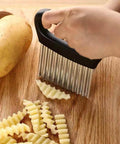 Crinkle cutter with stainless steel wavy blade and black handle; front view for potatoes and vegetables