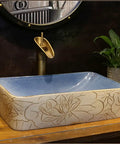 USZWBY Vessel Sinks Vessel Sink Lotus Pattern Art Countertop Basin Rectangular Ceramic Washbasin with blue interior top view.