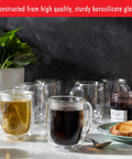 Four Piece Double Wall Insulated Glass Coffee Mug Set Keeps Hot Brews Steaming And Icy Drinks Frosty With Zero Sweat Marks Premium Borosilicate Glass Is Dishwasher Safe For Your Daily Grind Routine. Two mugs with hot drinks, sturdy borosilicate glass.