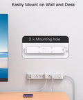 Gritty Heavy Duty Surge Protector Power Strip With Ten Foot Cord And Low Profile Plug serving six AC outlets plus four USB fast charging ports mounted on wall.