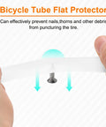 Two Pack PU Bike Tire Liners For 27.5 Inch Tires Puncture Proof Flat Protector in hand deflecting a nail