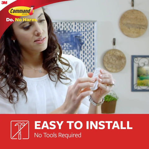 Person demonstrating installation of Medium Utility Hooks Set With 20 Hooks And 24 Strips Damage Free Hanging Wall Hooks.