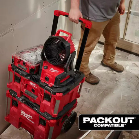 Person moving 18V Brushless Packout Fan With Lightning Fast Cooling, Beastly 850 CFM, 20.5 MPH Air Flow, Rugged Build With PACKOUT Modularity.