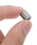 Close-up of a stainless steel threaded sleeve insert held between fingers, part of a Kit For Automotive Maintenance And Machinery Repair 10 Pack M8