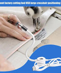 Plug And Play USB Laser Alignment Light With Slick Magnetic Mount For Sewing And Craft Cutting Delivering Crisp Red Cross Lines in use on fabric.
