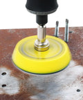 Close-up of drill using 100 Pack 2 Inch Sanding Discs Kit With Polishing Pad Plate on metal, showing smooth sanding and finishing.