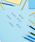 Top Tier 100 Pack Stainless Steel Compression Springs Kit For Ballpoint Pen Click Return Repair DIY Mechanical Tool Refurbishing Gear Silver Tone on blue background with pencils