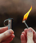 Permanent Fire Starter 5 Pack, Waterproof Metal Keychain Lighter in use with flame, ideal for camping stoves grills emergencies.