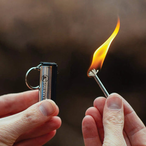 Permanent Fire Starter 5 Pack, Waterproof Metal Keychain Lighter in use with flame, ideal for camping stoves grills emergencies.