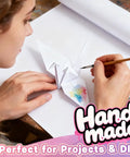 Person crafting origami with Heavy Duty White Kraft Paper Roll 15 Inch By 450 Inch 80Gsm Industrial Kraft Paper For Wrapping Gifts.