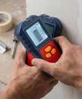 For Stud Finder Wall Scanner,5-in-1 Tester for stud Finder Metal Wire LCD held against wall, displaying wood stud detection.