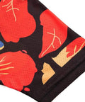 Close-up of black fabric with vibrant red and beige abstract patterns.