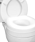 Raised Toilet Seat Riser Adds Five Inches Of Height For Most Standard Round Toilets With Slip Resistant Pads, shown on toilet