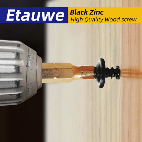 Close-up of a screwdriver bit driving a truss head black wood screw into wood from 120 Piece Size Eight Phillips Truss Head Black Wood Screw Kit