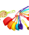 Colorful 12 Piece Measuring Cups And Spoons Set on white background with dry ingredients, dishwasher safe design.