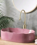 UMJIGF Vessel Sink Household Washbasin Bathroom Above Counter Basin pink basin with curved edges next to gold faucet.