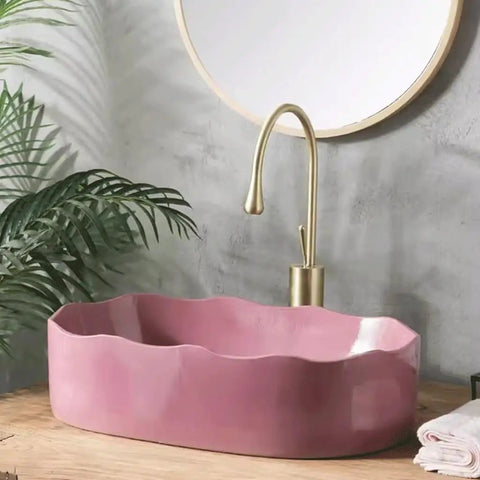 UMJIGF Vessel Sink Household Washbasin Bathroom Above Counter Basin pink basin with curved edges next to gold faucet.