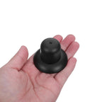Black plastic umbrella end cap, threaded spiral finial, palm-sized repair part for patio or beach umbrellas