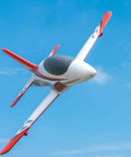 50mm EDF Jet RC Plane For Adults in flight against blue sky, red and white design, showcasing 4 channel remote control airplane features.