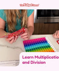 Children playing Number Ninja Multiplication And Division Game For Grades 2 Through 4, with colorful math flash cards on table.