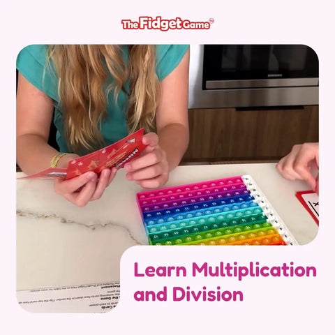 Children playing Number Ninja Multiplication And Division Game For Grades 2 Through 4, with colorful math flash cards on table.