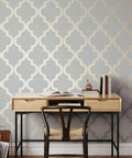 Dope Metallic Bronze Gray Marrakesh Peel And Stick Wallpaper Removable Self Adhesive Matte Trellis Design Pack Of 2 In 20.5 In X 16.5 Ft Made In The USA No Glue Needed No Residue on a wall behind a desk with chair.
