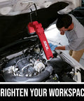 Heavy Duty Led Work Light 12 Volt Compact Task Lamp rock solid job site illumination used by mechanic under vehicle hood.