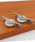 Smooth Gliding Sliding Door Rollers 4 Pack Heavy Duty Barn Door Wheels on wood surface, featuring stainless steel and white wheels.