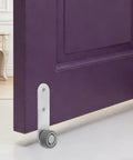 Premium 6 Pack Silver Sliding Door Roller Casters With Reinforced Steel Core And TPE Wheels Includes Anti Sagging Floor Guide For Barn Doors That Glide Damn Smooth Every Time, showing a caster guide installed on a purple door.