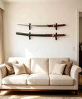 Dope Velvet Padded Sword Wall Mount Hanger For Katana Wakizashi Tanto Genji Daggers And Swords Adjustable 1.38 Inch Hook Width Easy Install Fits Samurai Weapon Rack Display On Wall. Velvet wall mount holds two swords above a beige couch in a living room setting.