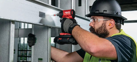 Worker using 22V Nuron SID 6 Cordless Brushless Impact Driver Tool Only With Quarter Inch Hex Quick Change for fastening metal beams