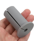 Get These Cool Silicone Wall Hole Plugs To Block Dirt And Water! Perfect 4 Pack For 25mm Cables Makes Home Improvement Super Easy With Gray And White Look. Gray silicone wall hole plug for 25mm cable, shown in hand