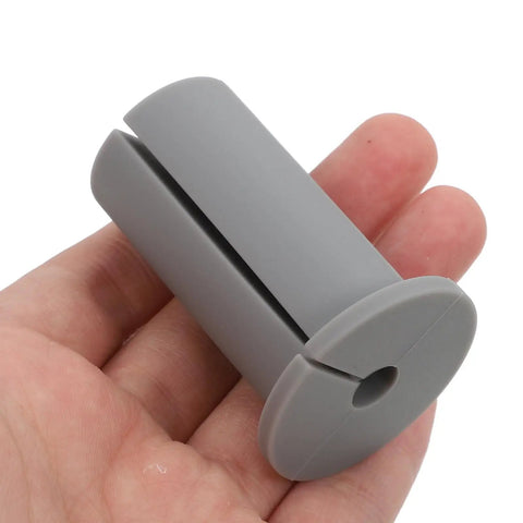Get These Cool Silicone Wall Hole Plugs To Block Dirt And Water! Perfect 4 Pack For 25mm Cables Makes Home Improvement Super Easy With Gray And White Look. Gray silicone wall hole plug for 25mm cable, shown in hand
